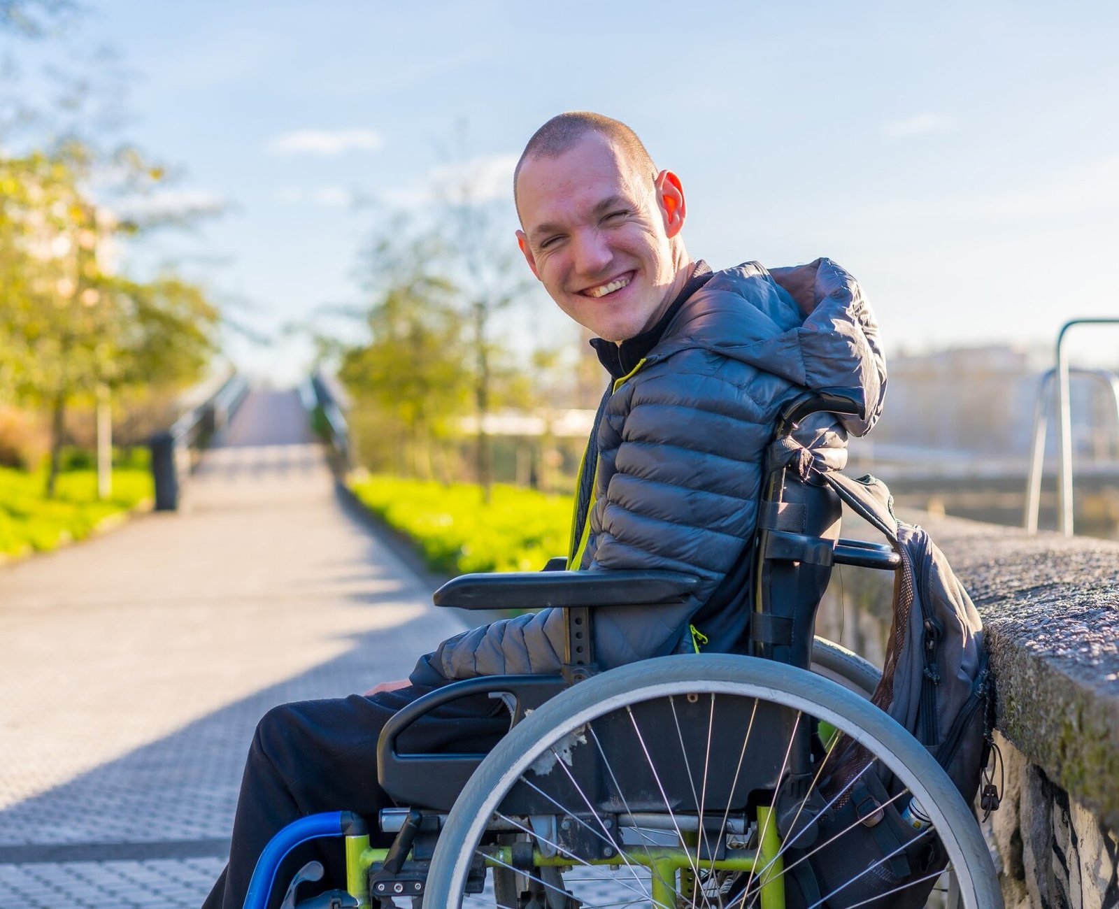 Portrait of a disabled person in a wheelchair in the city sunset